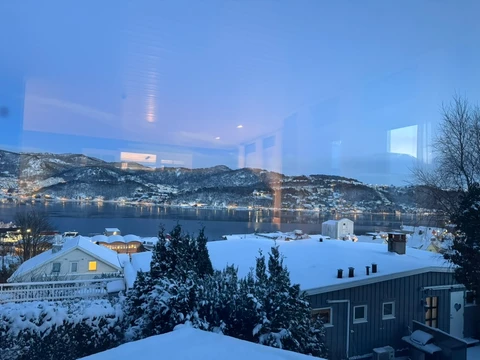 Snowy Norwegian coastal town at dusk